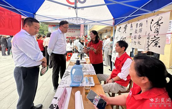“文化惠民”攤位上，志愿者展示書法作品_副本.jpg